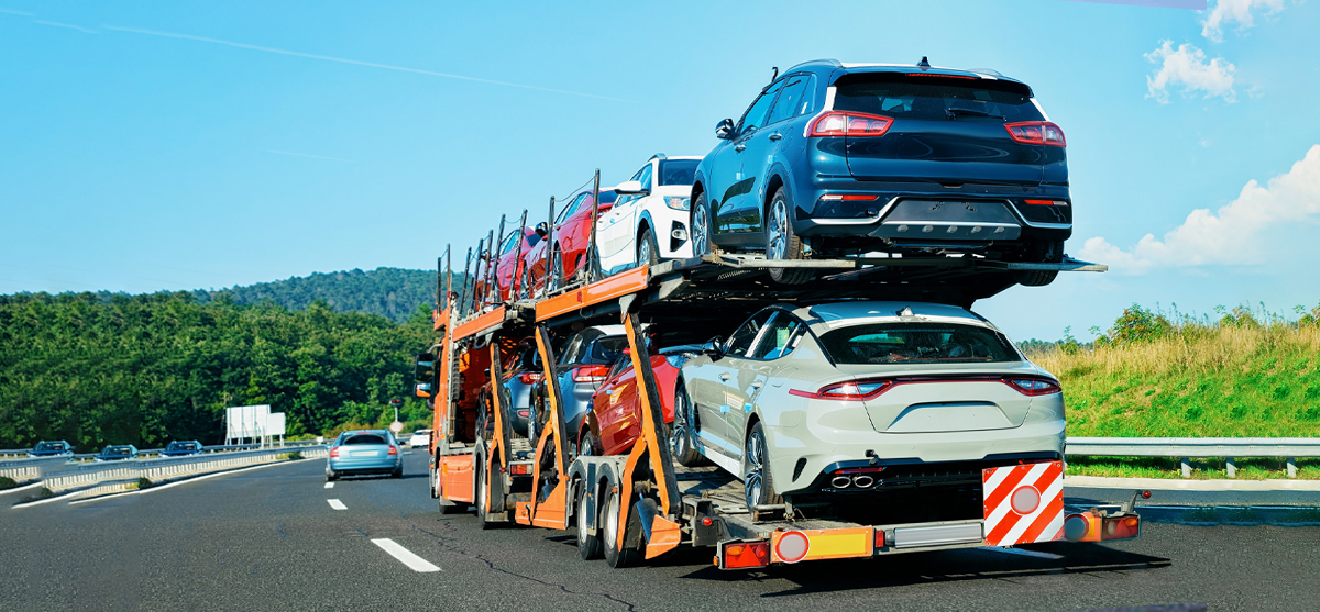cars uploaded on an open trailer